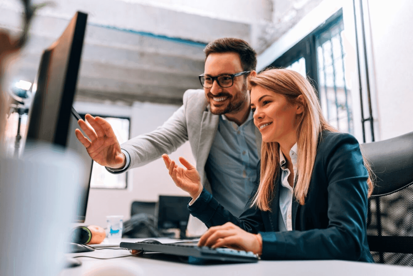 Two people having a meeting while using a laptop