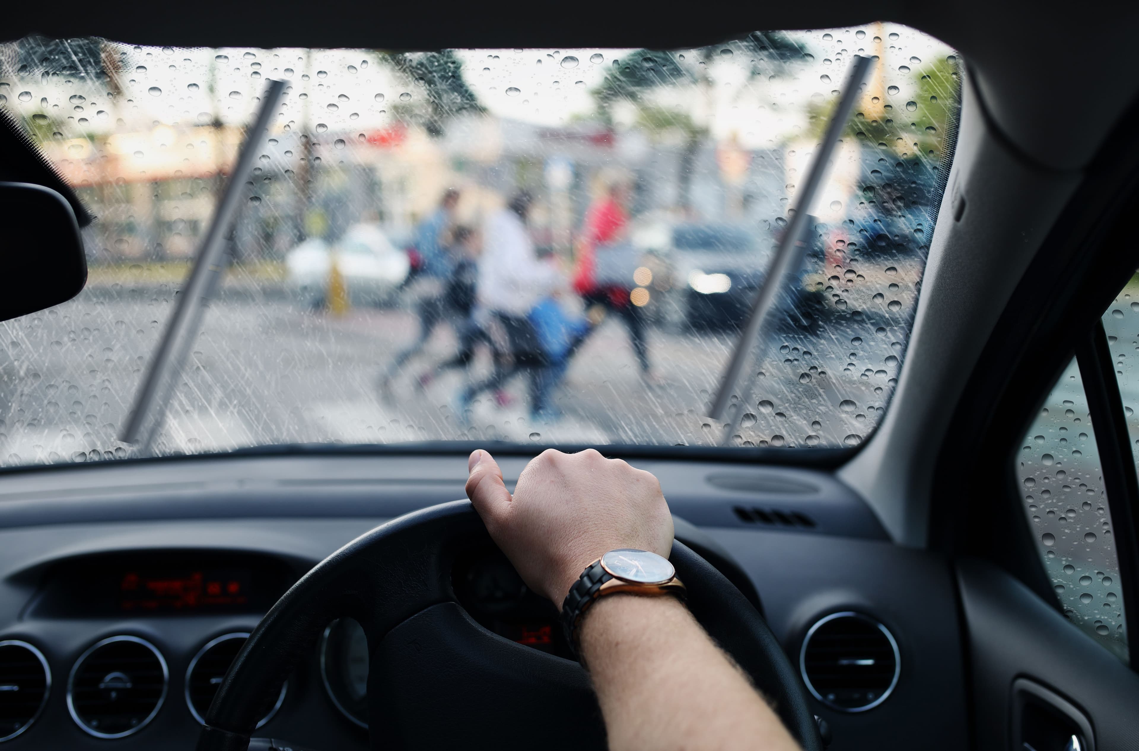 A driver approaching a zebra crossing while its raining