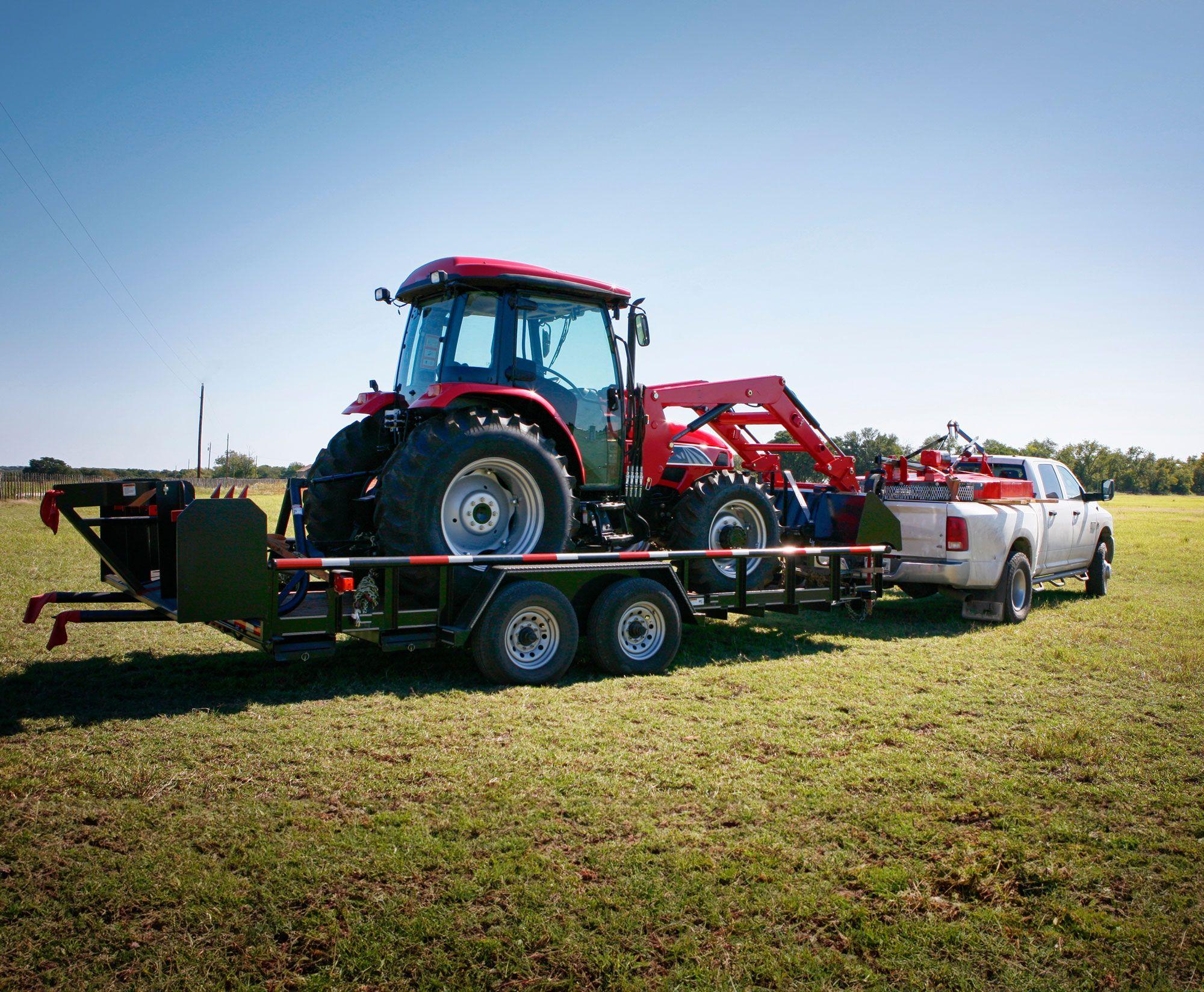 Red tractor on the back of a trailer