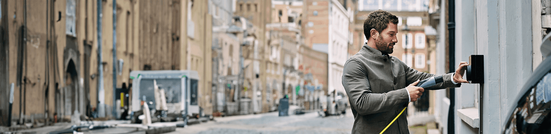 Someone plugging their charger into an electric chargerpoint