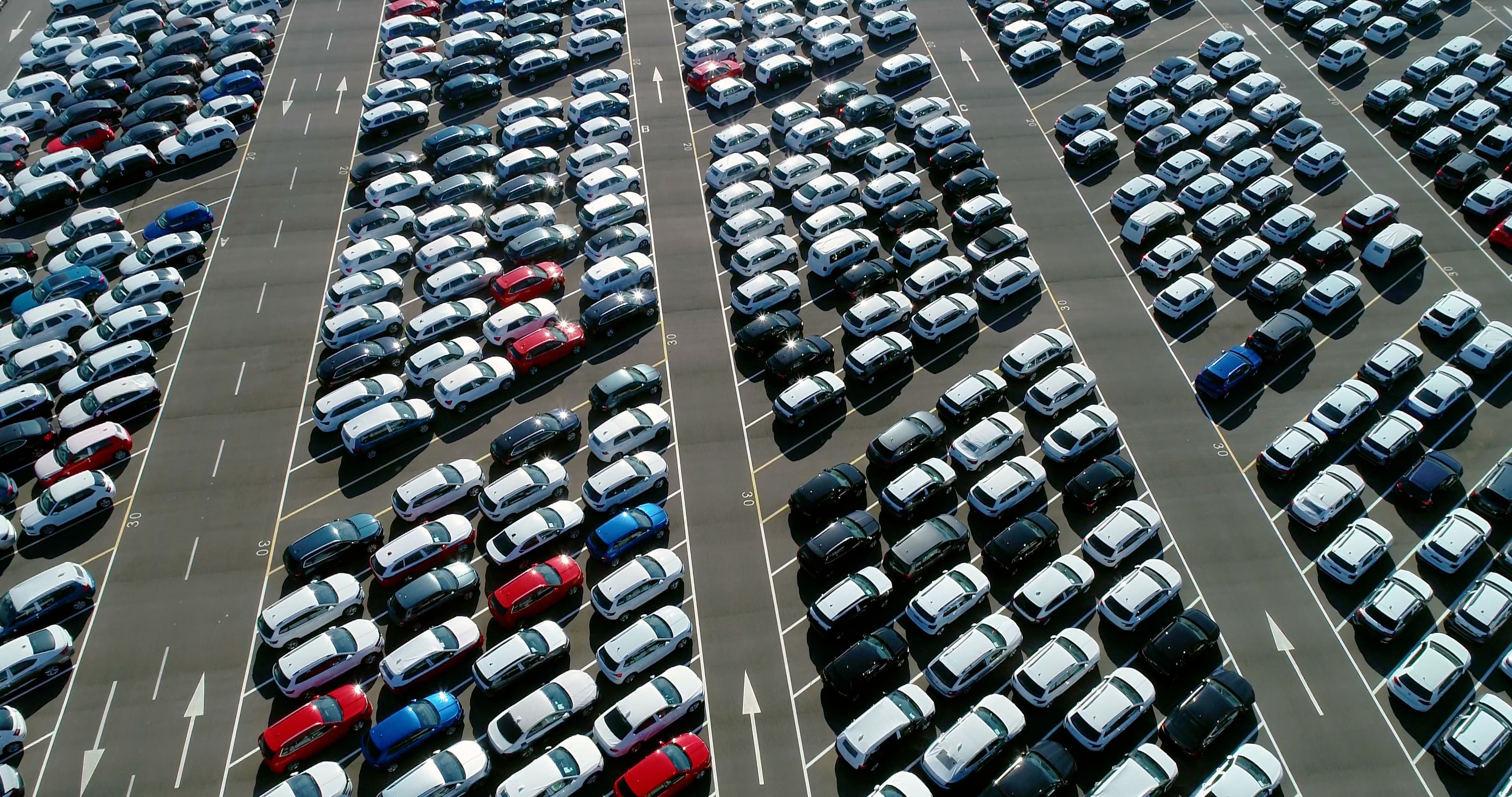 Lots of parked vehicles in a car park