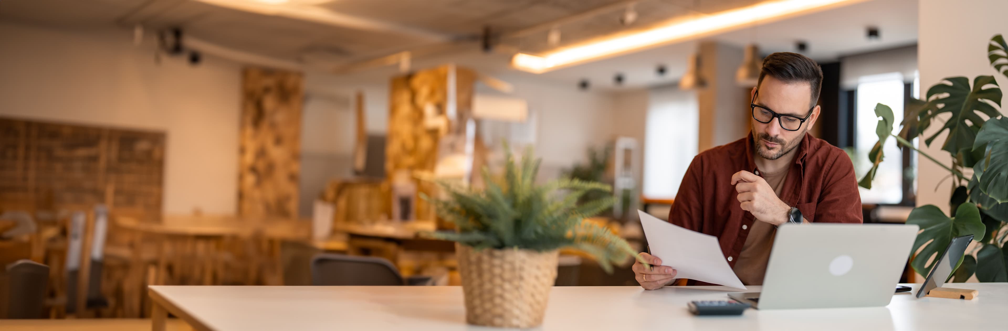 A person sat at a desk looking over paperwork