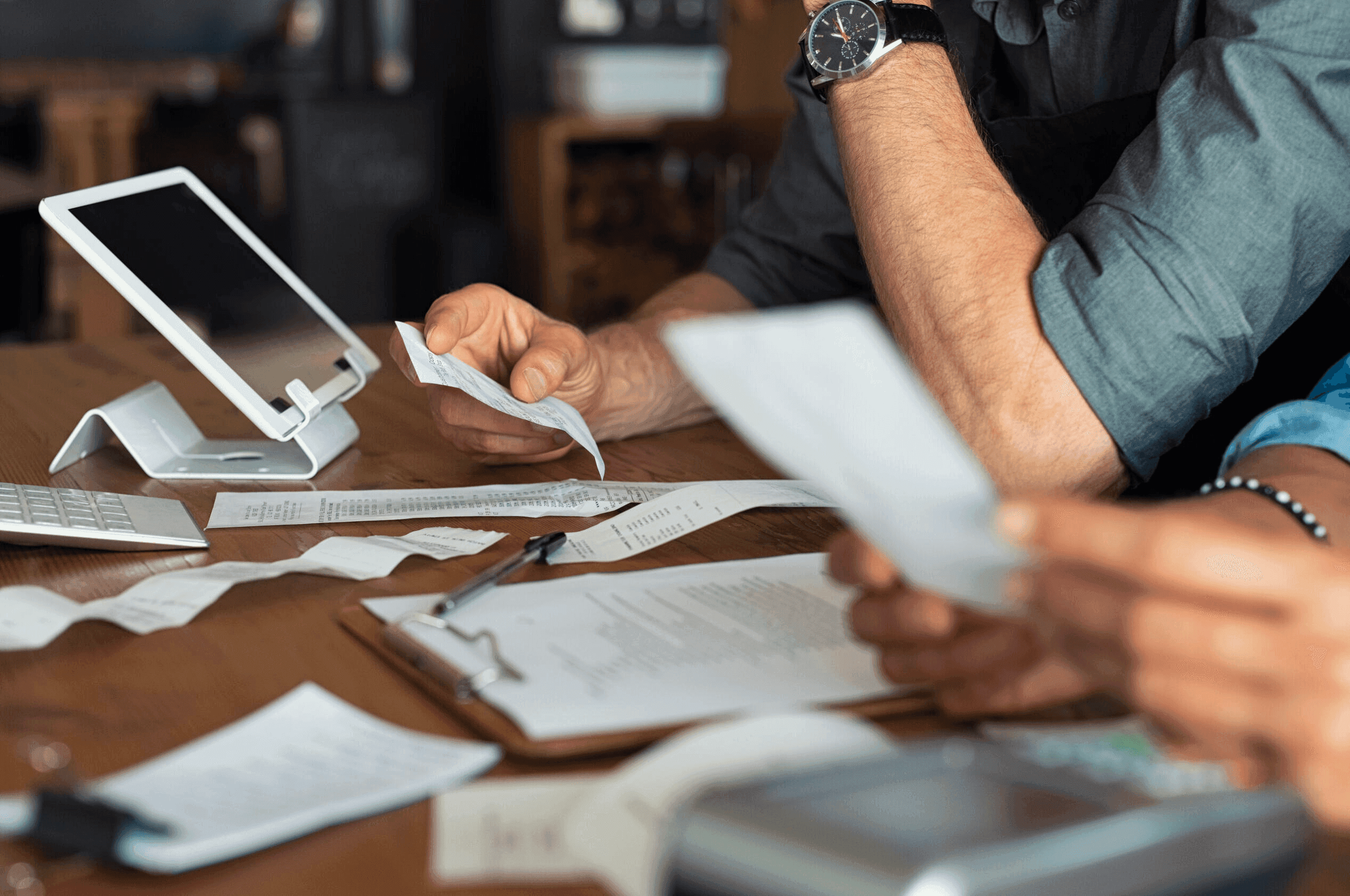 Two people looking over business receipts
