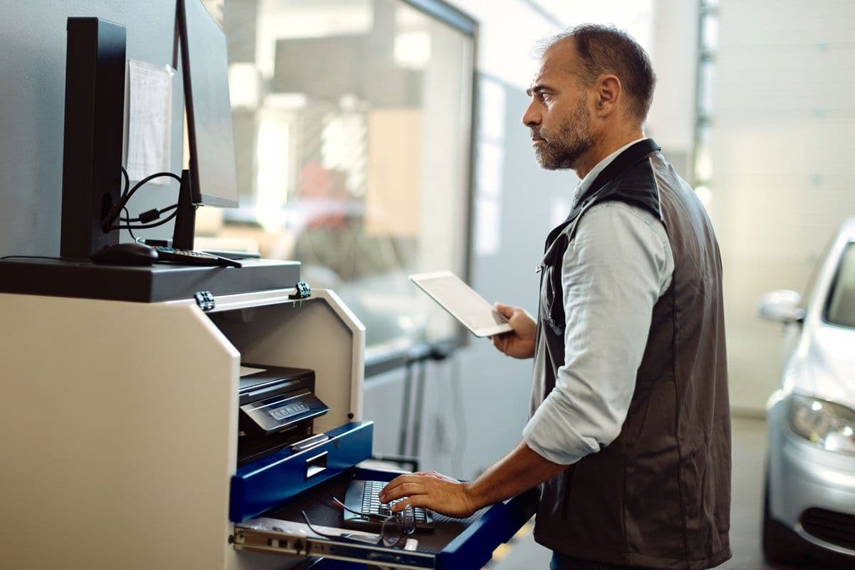 A mechanic using diagnostic equipment